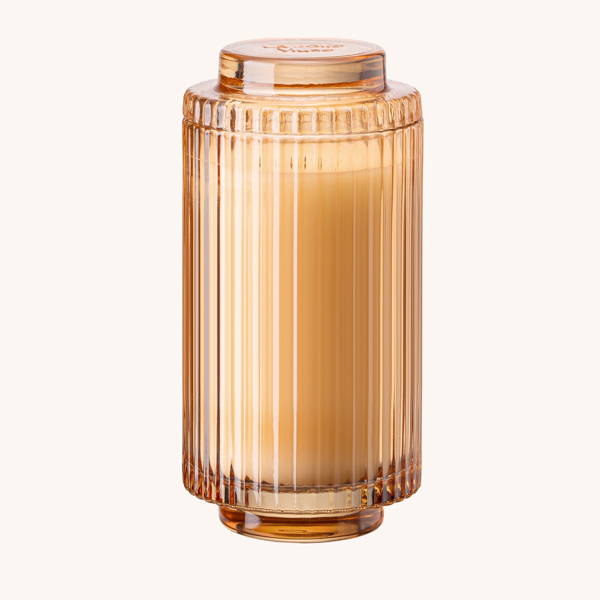 Amber-colored glass jar with ribbed design on a white background