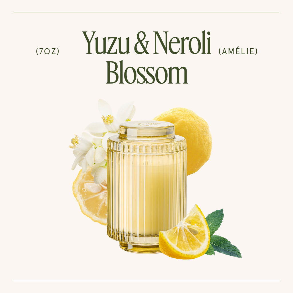 Glass of Yuzu & Neroli Blossom with lemons and flowers on a white background