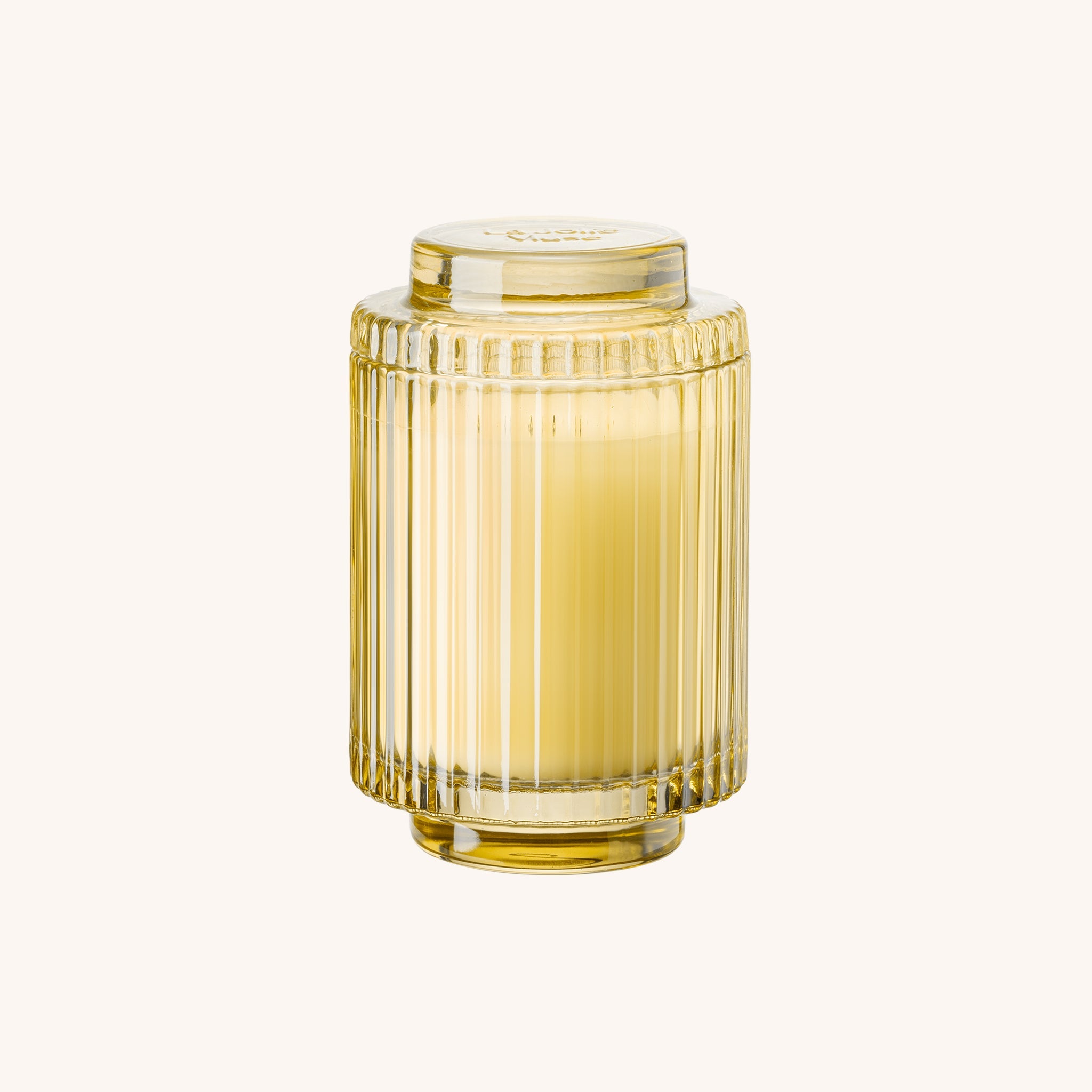 Yellow glass vase with ribbed design on a white background