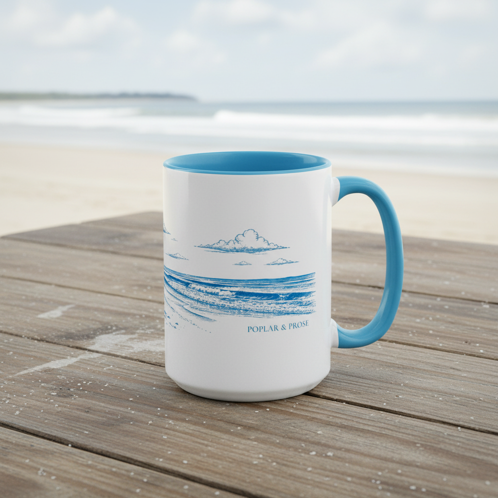 White mug with blue interior and handle on a wooden surface with a beach background, Poplar & Prose branding
