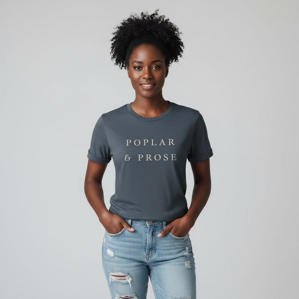 Woman wearing a dark heather blue t-shirt with 'Poplar & Prose' text on a plain background