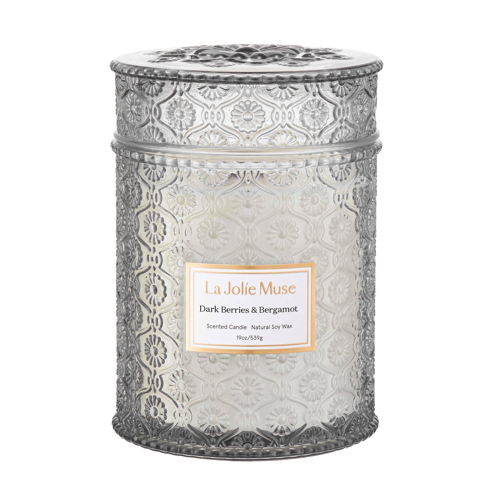 Decorative candle in a textured glass jar with a lid, featuring 'La Jolie Muse' on a white background.
