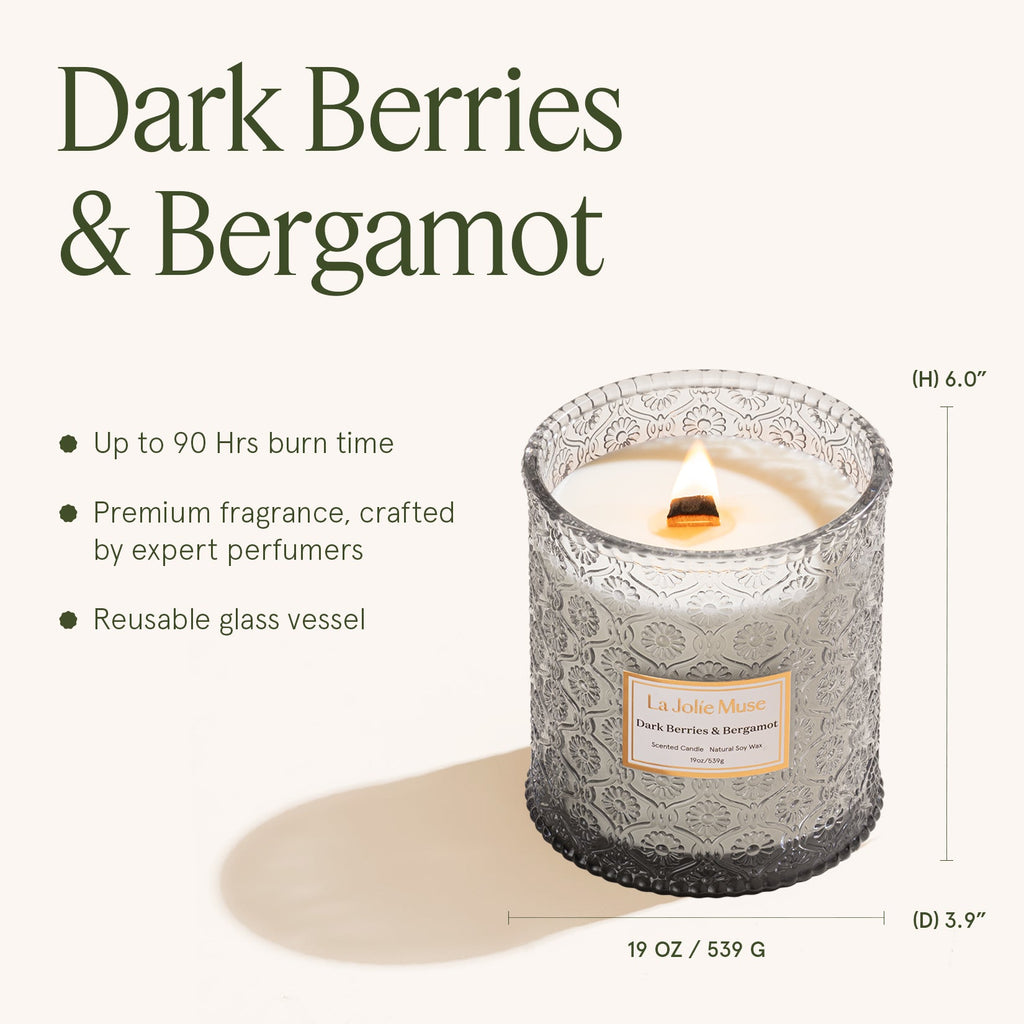 Candle with decorative glass vessel labeled 'Dark Berries & Bergamot' on a white background.