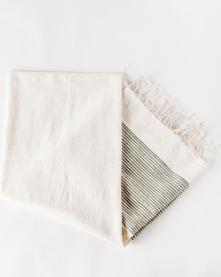 Folded towel with striped pattern on a white background