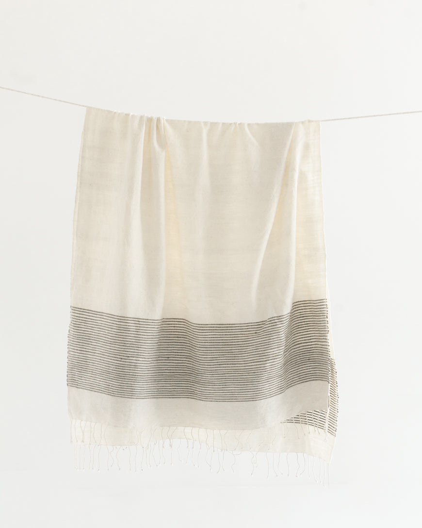 White-cream towel with gray stripes on a white background