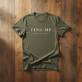 Green t-shirt with text 'FIND ME where it's quiet' on a wooden background