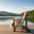 cream and gray striped Turkish cotton blanket with tassels, draped on Adirondack by the lake
