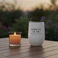 White wine tumbler inspired by Emily Dickinson with text on a wooden table with a candle in the background