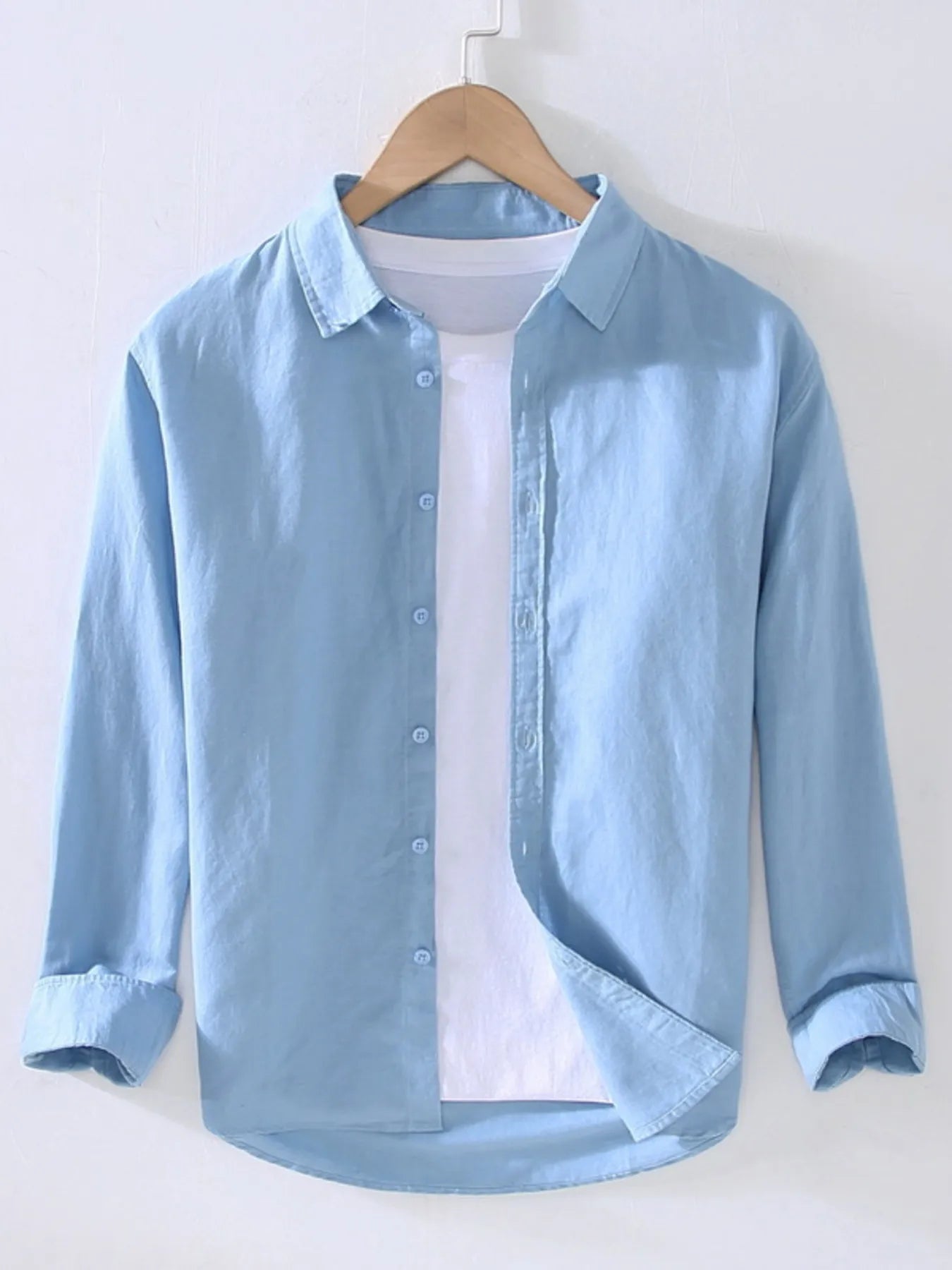 Weekend Cotton + Flax shirt in blue on a wooden hanger with white background