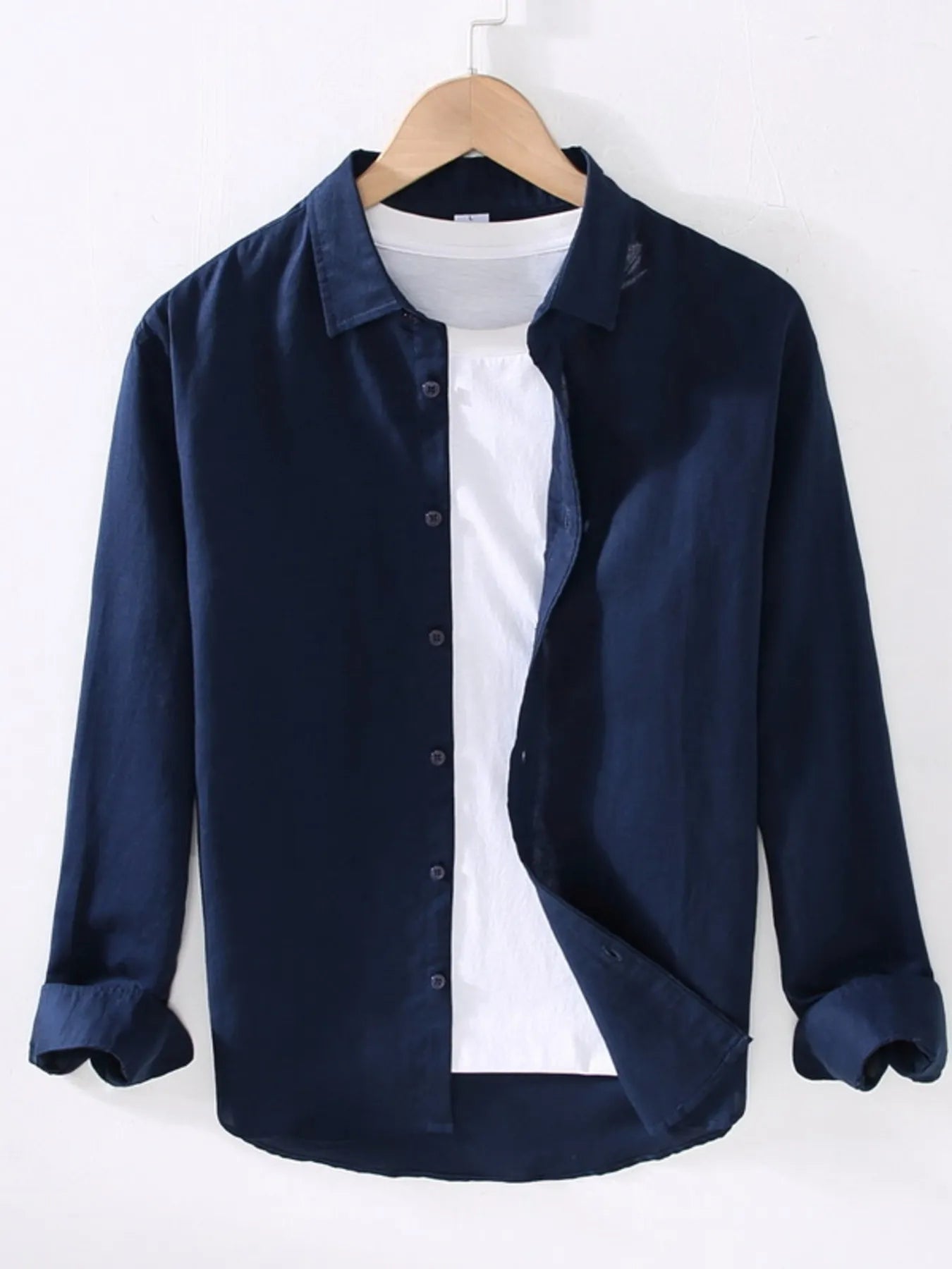 Weekend Cotton + Flax shirt in navy on a wooden hanger with white background