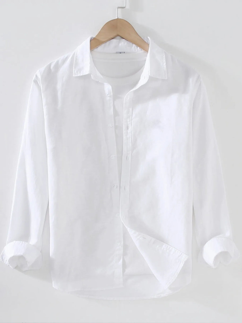 Weekend Linen shirt in white on a wooden hanger with white background