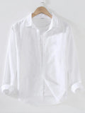 Weekend Linen shirt in white on a wooden hanger with white background