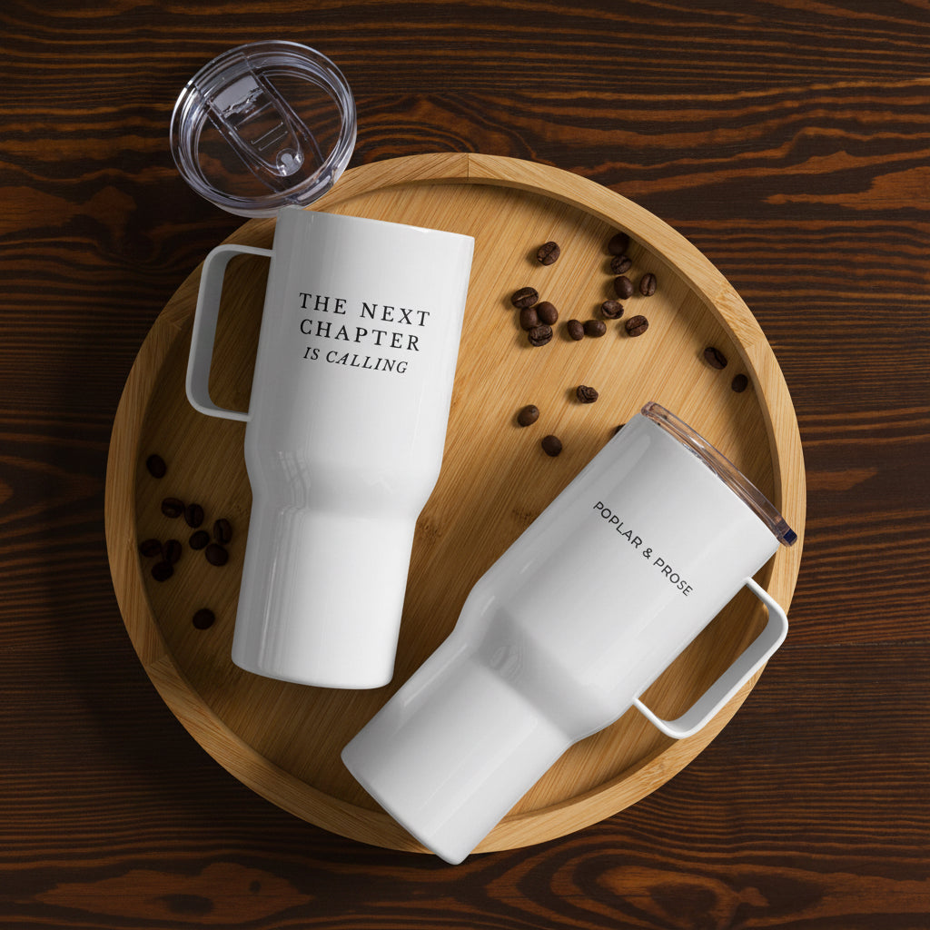 25 oz travel mug laying flat on wood surface with coffee beans