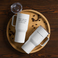 25 oz travel mug laying flat on wood surface with coffee beans